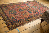 Tattered side, intricate dark blue and gold border of this antique Persian Lilihan rug.