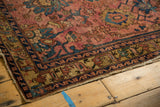 Aged pile and decorative borders of the antique Lilihan rug in raspberry red and dusty gold.