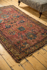 Antique Persian Lilihan rug with geometric border, tattered side, and secured end.