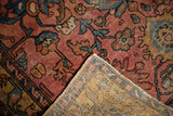 Worn raspberry pile of antique Lilihan rug revealing foundation, with hand-knotted reverse.