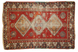 Antique Caucasian rug, cherry red field, triple diamond medallions, visible wear, 4'1