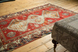 Antique Caucasian rug's border with reciprocating pawn motif, storied wear, and tattered edge.