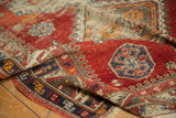 Visible cherry red pile and reciprocating pawn design motif on an antique Caucasian rug.