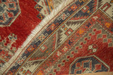 Hand-knotted construction and geometric pawn motif on an antique Caucasian rug.