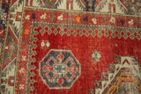 Antique Caucasian rug: cherry red field with octagonal and pawn motifs.