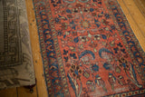 Raspberry red allover floral design on a vintage Lilihan rug, showing even wear.