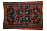 Antique Lilihan rug, black cherry red floral design on a navy field, early 20th century.