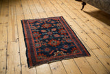 Intricate, contoured floral blossoms fill the Lilihan rug's dark navy field.