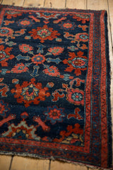 Close-up of a hand-knotted Persian Lilihan rug with intricate red and blue floral motifs.