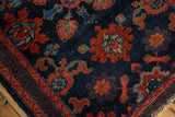 Antique Lilihan rug corner: intricate floral patterns, navy field, madder red border, wear to knot heads.
