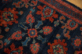 Antique Persian Lilihan rug: intricate red floral patterns, navy motifs, and visible wear.