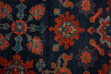 Close-up of Persian Lilihan rug with intricate floral motifs in madder root red and navy.