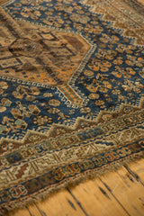 Detailed view of the Kamseh rug's intricate border, tattered edge, and navy, copper orange tones.