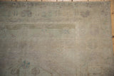 Distressed Oushak pile texture, showing even wear and tone-on-tone beige and mauve patterns.