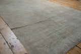 Distressed surface and muted beige, ivory, silver tones of a vintage Oushak rug.
