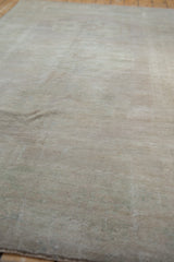 Detail of vintage distressed Oushak rug, showing muted beige and ivory pile texture.