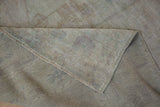 Reverse of the hand-knotted Oushak rug showing woven foundation, low pile, and identifying number.