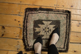 Thick pile and geometric starburst pattern on vintage Oushak rug, in brown, beige, and seafoam.