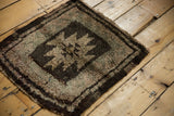Thick textured pile of the Oushak rug's secured edge, showing dark brown and beige bands.