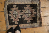 Thick pile Oushak rug detail: geometric starburst medallion in charcoal, mauve, tangerine.