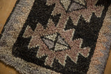 Thick pile vintage Oushak rug, geometric starburst, and zig-zag motifs in charcoal and mauve.