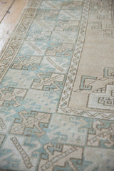 Distressed vintage Oushak rug's geometric border and field in dusty mint and beige.
