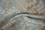 Distressed Oushak rug pile texture with geometric patterns in dusty mint and beige.