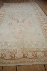 Low angle view along a vintage Oushak rug, showing the soft, even texture of its low pile.