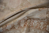 Softly draped vintage Oushak rug showing low pile texture in pale blush and copper bronze.