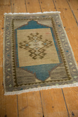 White fringe and muted geometric border detail on the distressed Oushak rug.