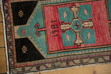 Distressed low pile, highlighting the 1981 date, aqua, and rose blush geometric pattern.