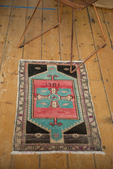 Vintage Oushak rug with 1981 date in quatafoil medallion, rose blush, aqua, charcoal.