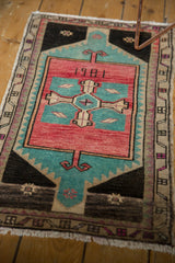 Lower corner of vintage Oushak rug with charcoal, aqua, rose, beige, and plum geometric border.