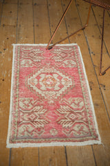 Distressed Oushak rug, blush and ivory, showing even wear, secured side, and fringe.
