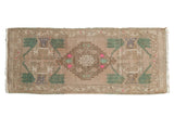 Distressed vintage Oushak rug runner, beige medallion with aqua green and pink plant motifs. 1'8
