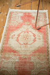 Distressed blush and beige vintage Oushak rug with even pile wear.