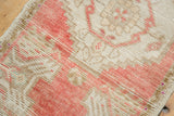 Blush and beige hand-knotted texture with even wear on a vintage Oushak rug.