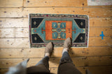 Top of a distressed vintage Oushak rug, pale copper quatrafoil on a sky blue field.