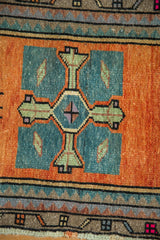 Geometric sky blue, beige border with distressed copper pile on a vintage Oushak rug.