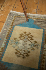 Vintage distressed Oushak rug's soft aqua, beige, and gold geometric border.