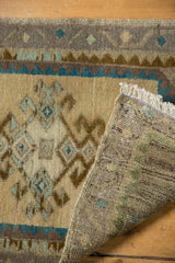 Distressed vintage Oushak rug mat detail showing rams horn border, low pile, and hand-knotted reverse.