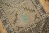 Distressed vintage Oushak rug, serrated leaf motifs in beige, sand, and mallard green.