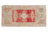 Vintage distressed Oushak rug with faded cherry red medallion, abrashed ivory, and blush field.