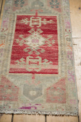 Fringe and geometric patterns on the low pile end of a distressed Oushak rug.