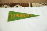 Vintage green felt Oswego pennant, highlighting textured material and yellow lettering.