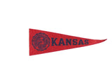Vintage University of Kansas red felt pennant with navy blue school seal and 'KANSAS' lettering.