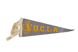Mini Vintage UCLA felt pennant with yellow lettering and school seal, 4x9 inches.