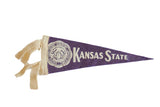 Mid-century purple felt Kansas State College pennant with cream lettering, seal, and ties.