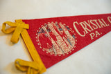 Cream 'Crystal' text on red felt vintage pennant.