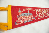 Red felt pennant with blue and peach building graphic and 'Roadside America' text.